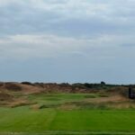 A fairway winding through the dunes on England's Golf Coast
