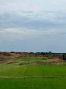 A fairway winding through the dunes on England's Golf Coast