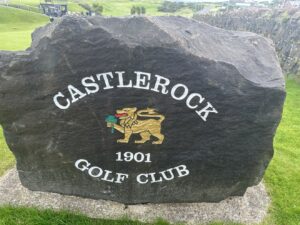 The entrance stone at Castlerock Golf Club in County Londonderry, Northern Ireland — the club's gold lion crest and its founding year, 1901