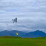 A flagstick on an Irish links green